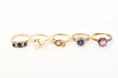 Lot 608 - Antique 18ct gold diamond three stone cross over ring, 18ct gold sapphire and diamond ring, 15ct gold amethyst single stone ring, 9ct gold gem set dress ring and a cultured pearl two stone ring (5)