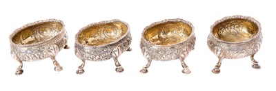 Lot 382 - Set of four George II silver salts of oval form, with embossed floral decoration