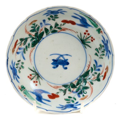 Lot 147 - Japanese Arita saucer, circa 1690-1740, polychrome painted with flowers, four-character mark to base, 13cm diameter