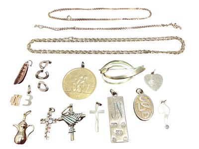 Lot 1 - Group of 9ct gold and yellow metal jewellery including three cross pendants, other pendants, charms, brooch and three chains