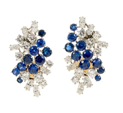 Lot 556 - Pair of good quality diamond and sapphire earrings, each with a stylised cluster of marquise cut and brilliant cut diamonds with round mixed cut blue sapphires in claw setting with white gold clip...