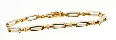 Lot 558 - 18ct white and yellow gold diamond bracelet with nine brilliant cut diamonds and articulated links, sponsor's mark AK Ld, London 1989, estimated total diamond weight approximately 0.54cts, 19cm.