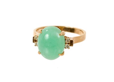 Lot 560 - Chinese jade and diamond ring with a oval green jade cabochon measuring 11.7 x 9.5mm flanked by diamonds to the shoulders on 14ct yellow gold shank, ring size L.