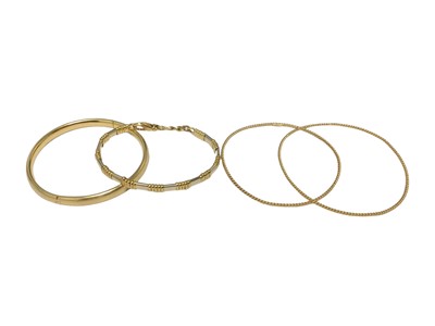 Lot 19 - 18ct yellow and white gold bracelet, 18ct gold hinged bangle and two other 18ct gold rope twist bangles (4)