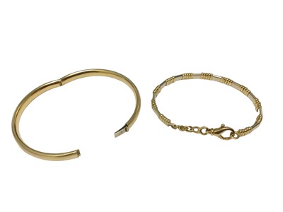 Lot 19 - 18ct yellow and white gold bracelet, 18ct gold hinged bangle and two other 18ct gold rope twist bangles (4)