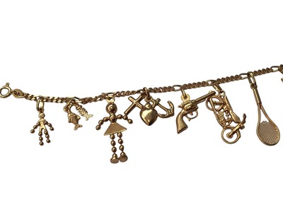 Lot 21 - 18ct gold charm bracelet with eleven 18ct gold novelty charms