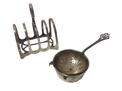 Lot 400 - Silver tea strainer with bowl and a silver toast rack (2)