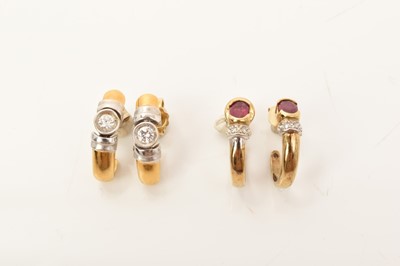 Lot 670 - Pair of 18ct white and yellow gold earrings set with a brilliant cut diamond weighing approximately 0.10cts each, together with a pair of 9ct gold ruby and diamond earrings (2)