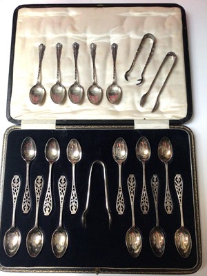 Lot 163 - Cased set of twelve silver plated teaspoons and pair of sugar tongs all with pierced thistle decoration, together with five silver teaspoons, pair of silver sugar tongs and another plated pair