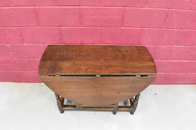 Lot 1389 - Late 17th century joined oak drop leaf dining table, with elliptical hinged top on turned and block understructure, 115 x 147cm extended