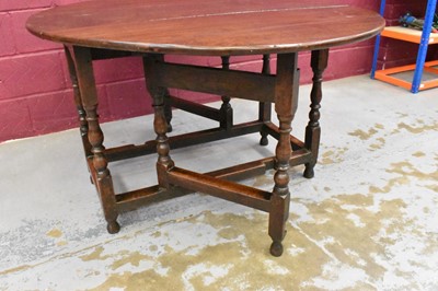 Lot 1389 - Late 17th century joined oak drop leaf dining table, with elliptical hinged top on turned and block understructure, 115 x 147cm extended