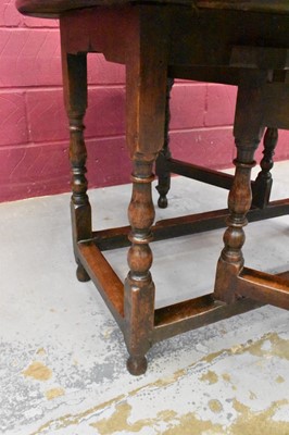 Lot 1389 - Late 17th century joined oak drop leaf dining table, with elliptical hinged top on turned and block understructure, 115 x 147cm extended