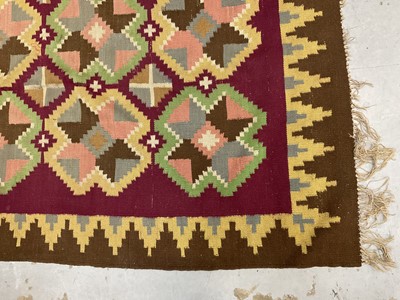 Lot 1424 - Large Kelim rug, with repeat cruciform motif on puce ground, signed, 310 x 197cm