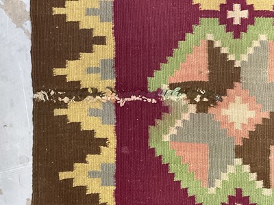 Lot 1424 - Large Kelim rug, with repeat cruciform motif on puce ground, signed, 310 x 197cm