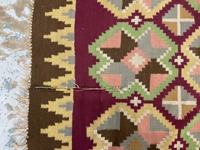 Lot 1424 - Large Kelim rug, with repeat cruciform motif on puce ground, signed, 310 x 197cm