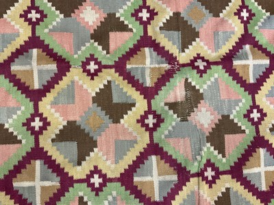 Lot 1424 - Large Kelim rug, with repeat cruciform motif on puce ground, signed, 310 x 197cm
