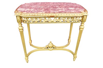 Lot 1415 - Louis XVI style giltwood and marble topped side table, the shaped top inset with rouge marble, and foliate-pierced frieze, raised on tapering fluted supports united by an undertier surmounted by an...