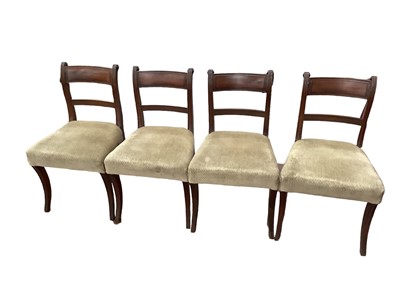 Lot 1355 - Set of four Regency mahogany dining chairs, each with tablet back and stuffover seats, on sabre legs