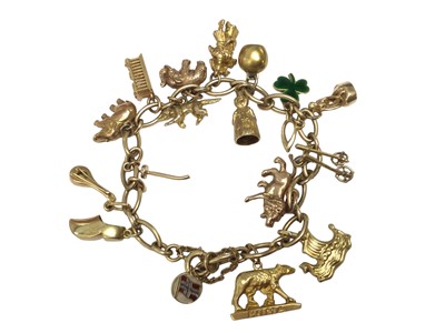 Lot 65 - 9ct gold charm bracelet with eighteen various gold, yellow metal and silver charms