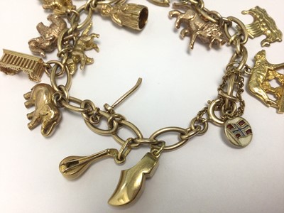 Lot 65 - 9ct gold charm bracelet with eighteen various gold, yellow metal and silver charms