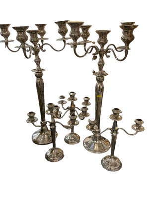 Lot 207 - Pair of modern silvered tall candelabra and pair of small silvered candlesticks