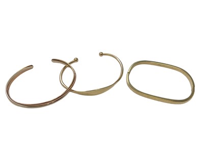 Lot 92 - 9ct gold hinged bangle, 9ct three colour gold triple band torque bangle and one other 9ct gold torque bangle (3)