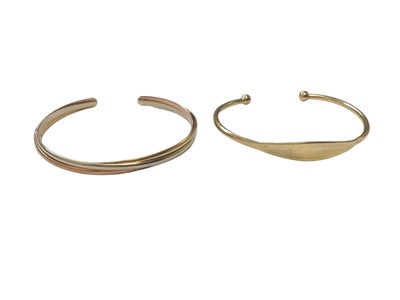 Lot 92 - 9ct gold hinged bangle, 9ct three colour gold triple band torque bangle and one other 9ct gold torque bangle (3)