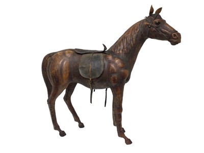 Lot 758 - Large leather covered wooden horse in the style of Liberty