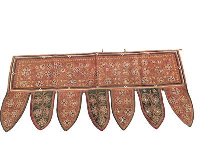 Lot 2065 - Two Vintage Indian Rajasthan Toran door hanging with frieze edging, finely embroidered in chain stitch with mirrors.  One handing has detached friese.