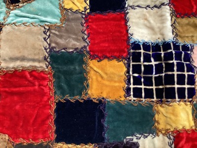 Lot 2069 - A selection of vintage textiles including an East European patchwork cover with geometric cross stitch panels connected with bobbin lace, small velvet patchwork panel, Iranian printed cotton cover...