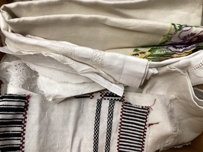 Lot 2069 - A selection of vintage textiles including an East European patchwork cover with geometric cross stitch panels connected with bobbin lace, small velvet patchwork panel, Iranian printed cotton cover...