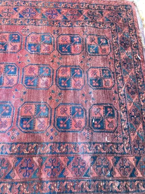 Lot 1438 - Antique Persian design rug with geometric medallions on dark red ground