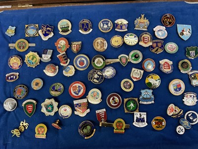 Lot 228 - Collection of enamel bowls club badges, including Essex, in a glazed cabinet. Approximately 70.