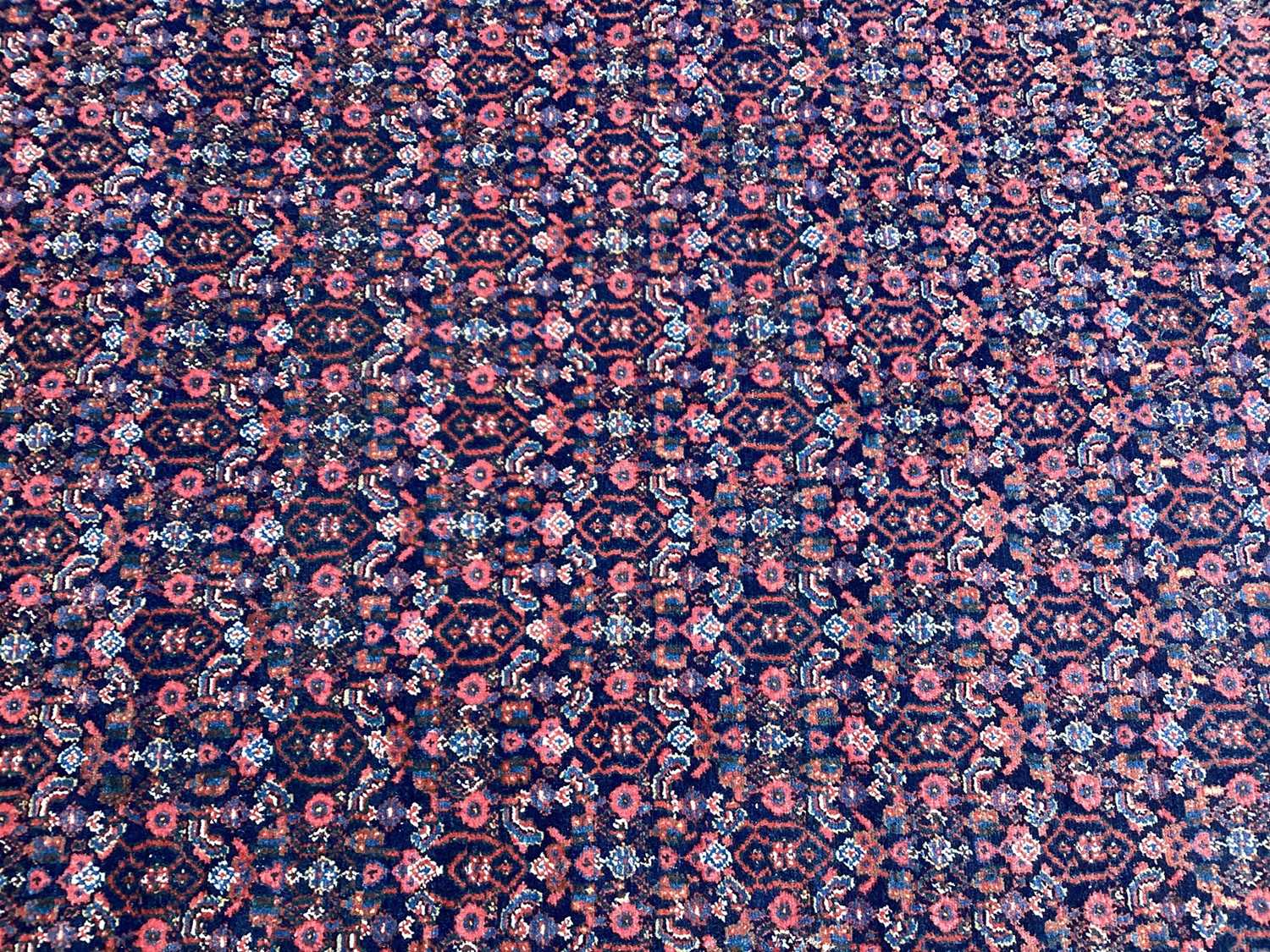 Lot 1435 - Persian design rug on red and blue ground