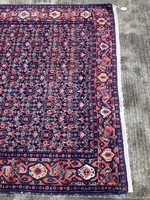 Lot 1435 - Persian design rug on red and blue ground