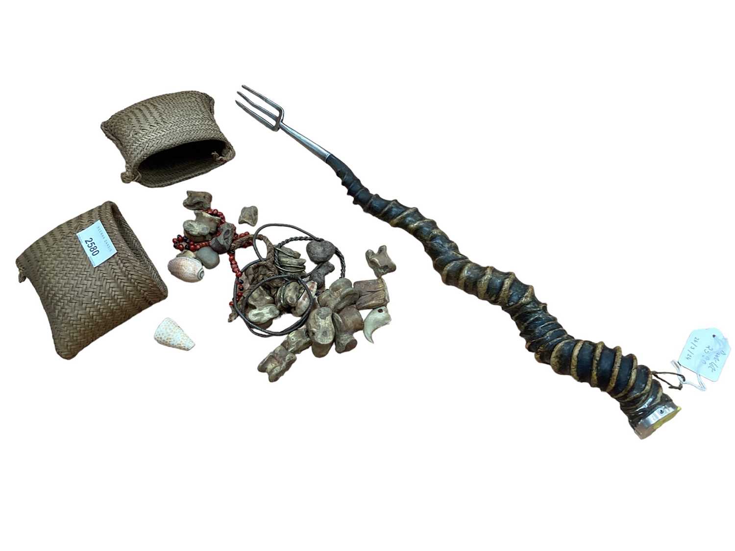 Lot 2580 - Lot old African Witch Doctors beads, bracelet in woven bag and Indian white metal mounted horn toasting fork