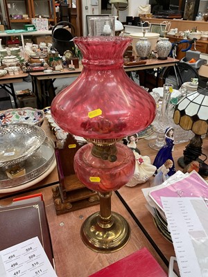 Lot 491 - Cranberry glass and brass oil lamp with shade