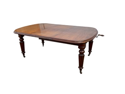 Lot 1378 - Victorian mahogany extending dining table with extra leaf on turned and reeded legs with winding handle.