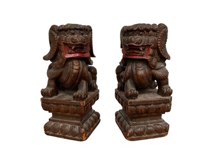Lot 167 - Pair of carved wooden temple lions.