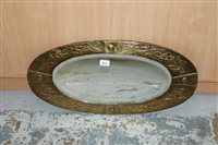 Lot 3637 - Arts & Crafts oval mirror with brass repoussé...