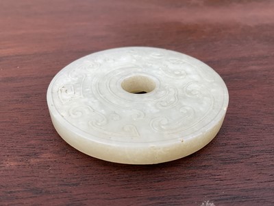 Lot 760 - Celadon jade chilong bi disc, probably 19th century