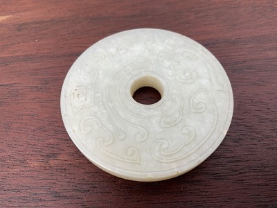 Lot 760 - Celadon jade chilong bi disc, probably 19th century