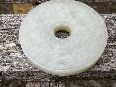 Lot 760 - Celadon jade chilong bi disc, probably 19th century