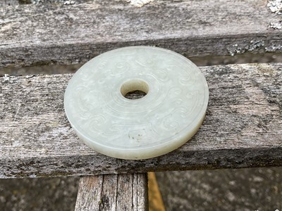 Lot 760 - Celadon jade chilong bi disc, probably 19th century