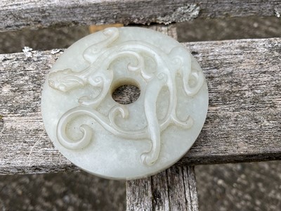 Lot 760 - Celadon jade chilong bi disc, probably 19th century