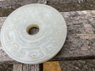 Lot 760 - Celadon jade chilong bi disc, probably 19th century