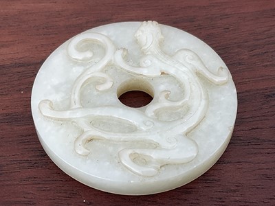 Lot 760 - Celadon jade chilong bi disc, probably 19th century