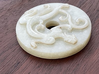 Lot 760 - Celadon jade chilong bi disc, probably 19th century