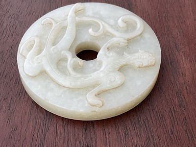 Lot 760 - Celadon jade chilong bi disc, probably 19th century