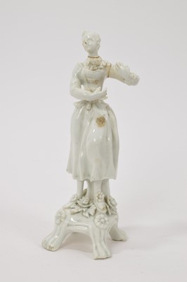 Lot 30 - Lowestoft white glazed figure of a female lute player